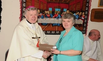 Bridget McGinty makes a presentation to Archbishop Neary on behalf of the Centenary Committee