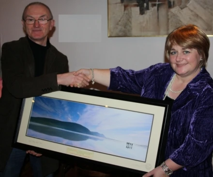 Maureen McGreal, on behalf of the Centenary Committee, makes a presntation to Des Kilbane in appreciation of his work on the DVD